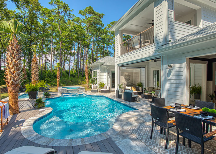 Coastal home at Kingfish Bay featuring a private pool, outdoor dining area, and open-air living spaces